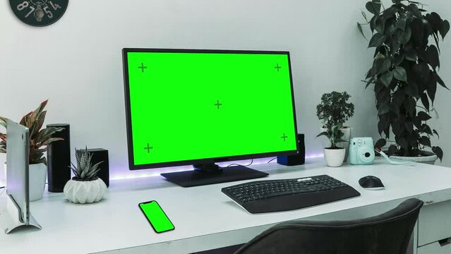 Computer desk and phone green screen, chroma keying, closeup shot of green screen, and a screen tracking layer. 4k footage.