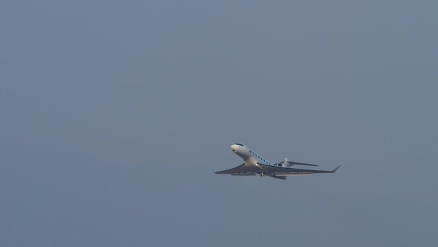 Business jet of Private owner takeoff and climb at Hong Kong airport, long shot