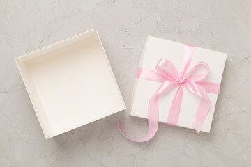 White open gift box on concrete background, top view