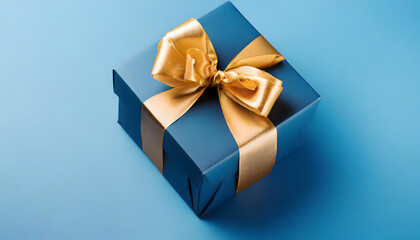 Stylish Blue Gift Box with a Golden Bow on a Blue Background for Father's Day with copyspace