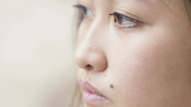 pensive serious Asian woman portrait: closeup portrait