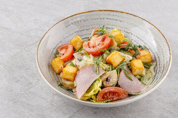 salad with ham and halloumi cheese on a stone background studio food photo 9