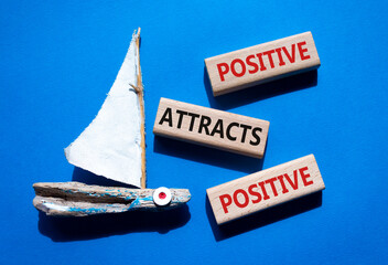 Positive attracts Positive symbol. Wooden blocks with words Positive attracts Positive. Beautiful...