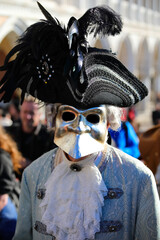 Venice, VE, Italy - February 13, 2024: masked person with big noise and black hat at Venetian...