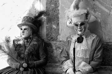 Obraz premium Venice, Italy - February 2024 - carnival masks are photographed with tourists in San Marco square