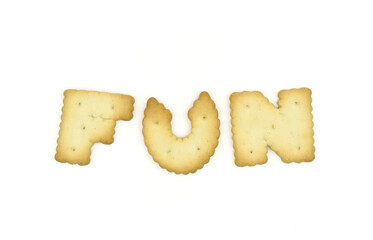Capital letter shaped biscuits forming word FUN isolated on white background