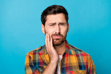 Photo portrait of handsome young male touch cheek toothache pain suffer dressed stylish checkered outfit isolated on blue color background