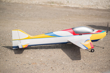 A flying model of a game plane on the asphalt in summer
