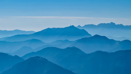 Panoramic view of magical mountain peaks of Karawanks and Julian Alps seen from Goldeck, Latschur group, Gailtal Alps, Carinthia, Austria, EU. Mystical atmosphere in Austrian Alps on sunny summer day.