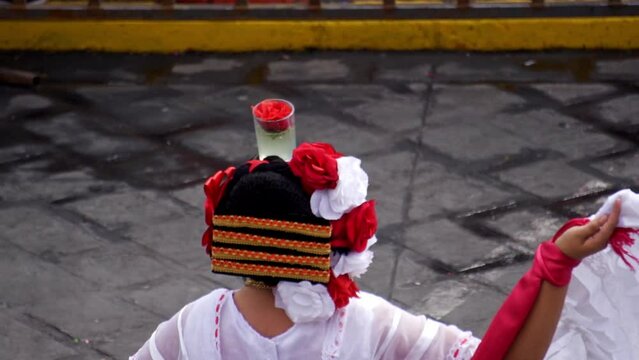 Close up of the hairstyle and head ornaments of a woman dancing a mexican cultural folkloric dance sharing the different ethnic dances of veracruz mexico. concept of mexican culture