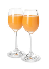 Tasty tangerine liqueur in glasses isolated on white