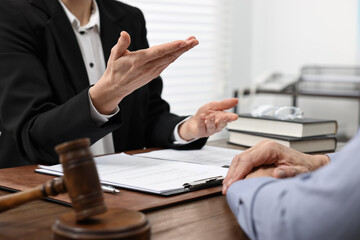 Senior man having meeting with lawyer in office, closeup