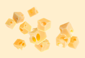 Pieces of cheese flying on beige background