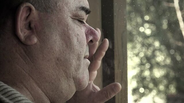 depressed man at home looking outside: tilt movement footage