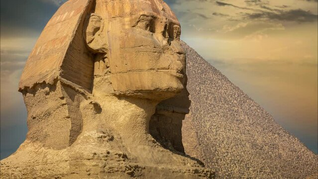 The Great Sphinx of Giza showing a side view of the head and face with the pyramid in the background.