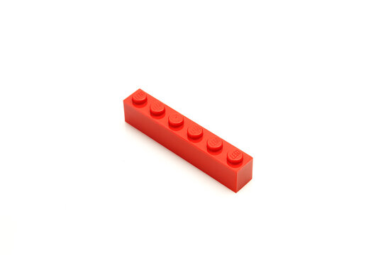 Single red lego plastic brick isolated on white background