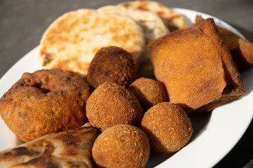 Authentic Sri Lankan different street food, short eats. Vegetable roti, Chinese rolls, coconut roti, cutlets, mutton rolls. Snacks made with tuna, potatoes, onion and deep fried. Close up.