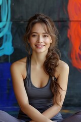 A portrait of a young woman in sportswear, exuding strength and determination during a boxing workout.