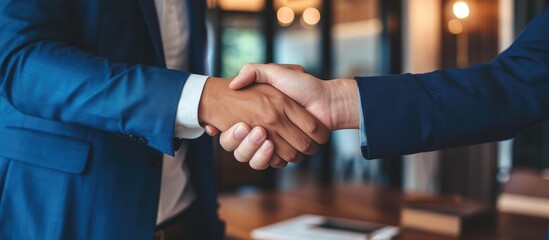 Real estate agent and customers marking a successful deal through a celebratory handshake after completing home insurance and investment loan agreement.