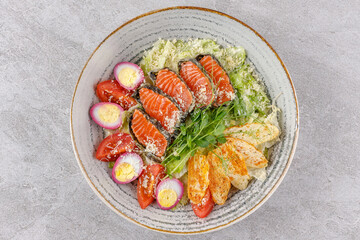 Caesar salad with baked salmon on a stone background studio food photo 4