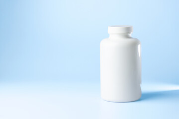 bottle syringe for injectable medication on blue background