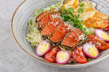 Caesar salad with baked salmon on a stone background studio food photo 7