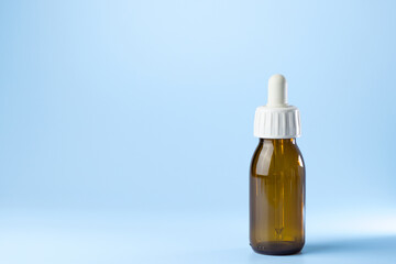bottle syringe for injectable medication on blue background