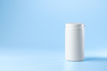 bottle syringe for injectable medication on blue background