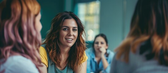 Female coach or team manager providing support and motivation to young women in a therapy session or staff training meeting.