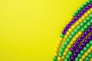 Colorful beads on yellow background. Top view with copy space