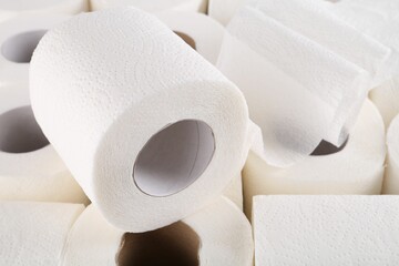 Many soft toilet paper rolls as background, closeup