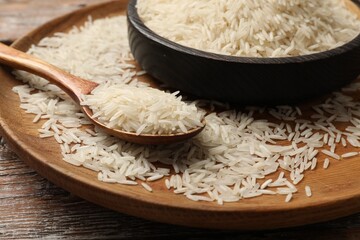 Raw basmati rice on wooden table, closeup