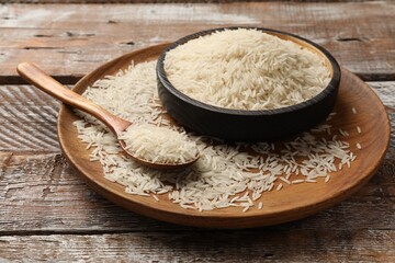 Uncooked raw basmati rice on wooden table
