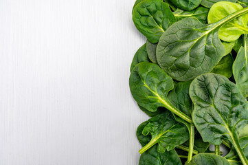 Fresh green baby Spinach leaves, diet and health concept, weight loss, spinach background top view...