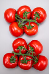 Red ripe tasty Dutch tomatoes growing indoor in greenhouse all seasons, food industry in Netherlands close up