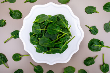 Fresh green baby Spinach leaves, diet and health concept, weight loss, spinach on ceramic plate,...