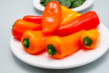 Fresh red, orange, and yellow sweet bell paprika close up