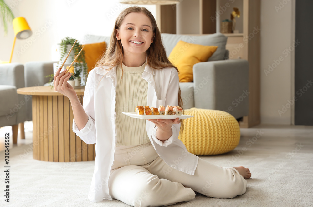 Canvas Prints Happy young woman eating sushi in living room