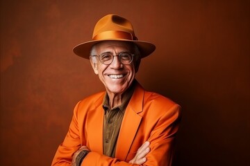 Portrait of a happy senior man in orange suit and hat.