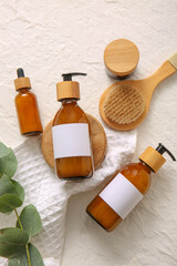 Bottles of shampoo, brush and cosmetic products on white background