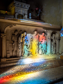 Stained light blessing a holy scultpure in a church