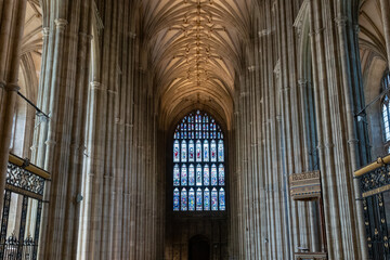 Stunning Gothic arches on ceiling of nave with a stained glass window at the end