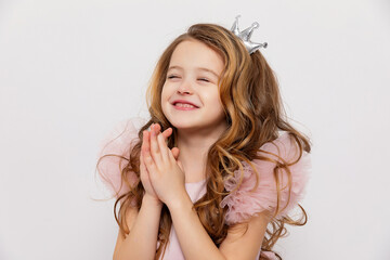 Cute little girl makes a wish on the birthday party. Happy girl celebrating her birthday. copy space.