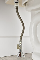 Toilet water feed line. Water valve on toilet inlet with braided hose. Ball valve vertical...