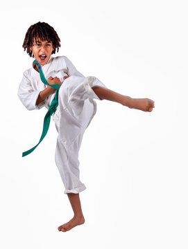 African American Boy In Karate Suit Training, Uniform Karate Gi , Keikogi Or Dogi, Suit Is White, Hairstyle With Braids, Dreadlocks, Isolated On White Background