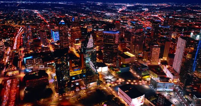 Flight above the luminous scenery of Dallas, Texas, USA. Life of a vibrant metropolis at night.