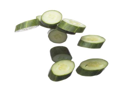 Cucumber fly fall, green fresh vegetable cucumber cut chop slice. Organic fresh vegetable with eaten leaf of long cucumber, close up texture. White background isolated freeze motion high speed shutter