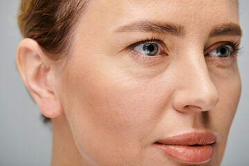 good looking blonde woman with contact lenses on eyes posing on gray backdrop and looking away - 738363955