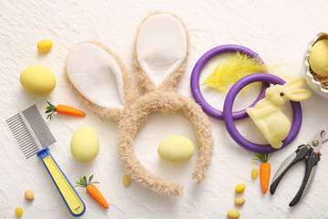 Bunny ears with Easter eggs and pet groomer tools on white grunge background