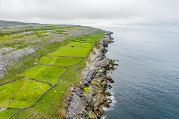 Spectacular misty aerial landscape in the Burren region of County Clare, Ireland. Exposed karst...